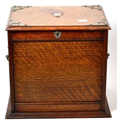 Lot 524 - An Edwardian White Metal Mounted Oak Smoker's Compendium, with hinged top and tambour front...