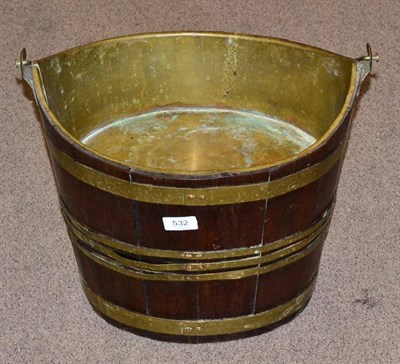 Lot 532 - A Brass Bound Mahogany Bucket, 19th century, of oval form with swing handle, 37cm high