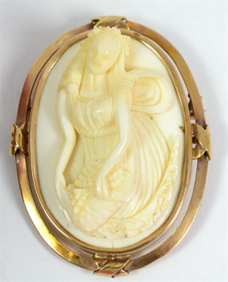 Lot 547 - An Indo-Portuguese Ivory Cameo, late 19th century, as a classical maiden holding an apron of fruit