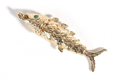 Lot 590 - A 9 Carat Gold Articulated Fish Pendant, with round cut emerald set eyes, length 6.5cm