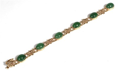 Lot 591 - A 9 Carat Gold Nephrite Bracelet, oval cabochon nephrite in claw settings, spaced by sunflower...