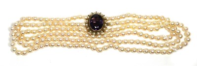 Lot 596 - A Cultured Pearl Necklace, with an Amethyst and Pearl Clasp, three strands of uniform cultured...