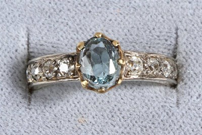 Lot 600 - A Blue Topaz and Diamond Ring, an oval cut blue topaz in a claw setting, to a shank inset with...