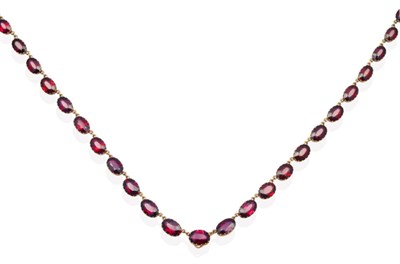 Lot 602 - A Garnet Riviere Necklace, graduated oval cut garnets in collet settings, length 46cm