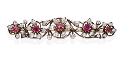 Lot 607 - A Ruby and Diamond Brooch, five flower heads, each with a central round cut ruby in a claw...