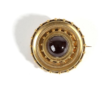 Lot 609 - A Garnet Target Brooch, a round cabochon garnet in a rubbed over setting, within a circular...