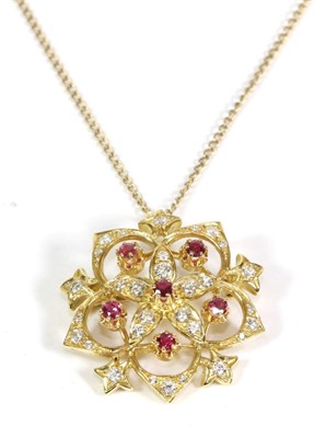 Lot 618 - A Ruby and Diamond Brooch/Pendant, on Chain, a flower shaped pendant set with six round cut...