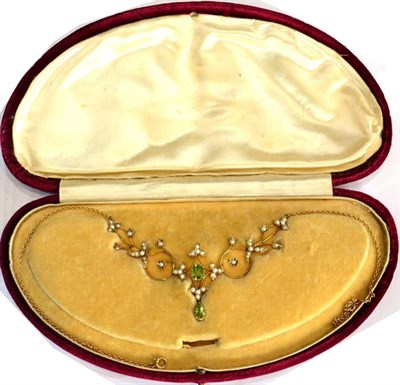 Lot 619 - An Art Nouveau Peridot and Seed Pearl Necklace, an octagonal cut peridot in a claw setting within a