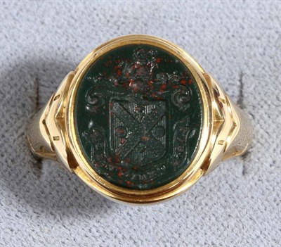 Lot 636 - A Bloodstone Intaglio Signet Ring, an oval intaglio seal engraved with a coat of arms, inset to...