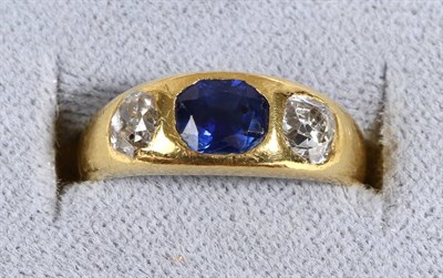 Lot 638 - A Sapphire and Diamond Three Stone Ring, an oval cut sapphire between old cut diamonds, inset...