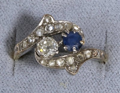 Lot 654 - A Sapphire and Diamond Ring, a round cut sapphire and an old cut diamond in claw settings, to...