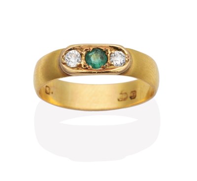 Lot 656 - An Emerald and Diamond Three Stone Ring, a round cut emerald between old cut diamonds to an...