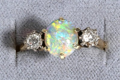 Lot 660 - An Opal and Diamond Three Stone Ring, an oval cabochon opal in a claw setting, between old cut...