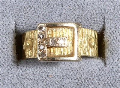 Lot 668 - An 18 Carat Gold Diamond Buckle Ring, an eight-cut diamond inset buckle to a textured belt,...