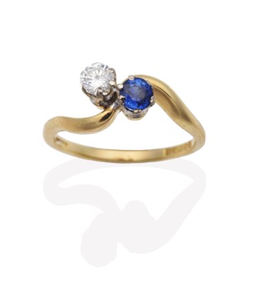 Lot 670 - An 18 Carat Gold Sapphire and Diamond Two Stone Ring, a round cut sapphire and a round...