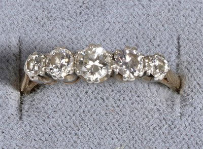 Lot 674 - A Diamond Ring, five graduated round brilliant cut diamonds in claw settings, to knife edge...