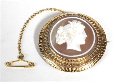 Lot 676 - A Carved Shell Cameo Brooch, a circular cameo depicting a classical  female bust, in a two tier...