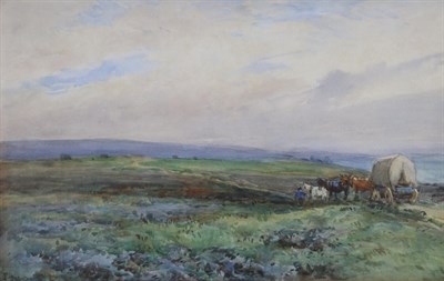 Lot 1186 - John Atkinson (1863-1924)  Horse drawn caravan and figure moving along a coastal pathway Signed and