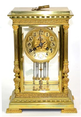 Lot 1219 - A Brass Four Glass Striking Mantel Clock, circa 1900, Corinthian columns, bevelled panels,...