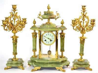 Lot 1274 - A Green Onyx Striking Mantel Clock Garniture, early 20th century, four glass gilt metal mounted...