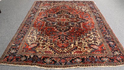 Lot 1317 - Heriz Carpet Iranian Azerbaijan, circa 1940 The stepped terracotta field of angular vines around an