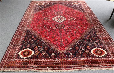 Lot 1320 - Kashgai Rug South West Iran, 20th century The raspberry field of tribal motifs around a...