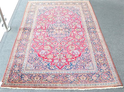 Lot 1322 - Kashan Rug Central Iran, circa 1940 The raspberry field of vines around an indigo medallion...