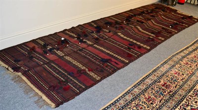 Lot 1326 - Balouch Kilim Afghanistan, 20th century The field woven in two parts, of polychrome bands, 387cm by