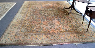 Lot 1345 - European Carpet Possibly Donegal, circa 1910 The cream field of vines around a flowerhead medallion