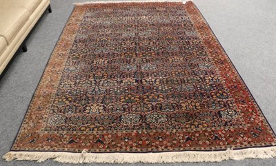 Lot 1352 - Hereke Wool Carpet North West Anatolia, circa 1950 The indigo oval lattice field of stylised plants