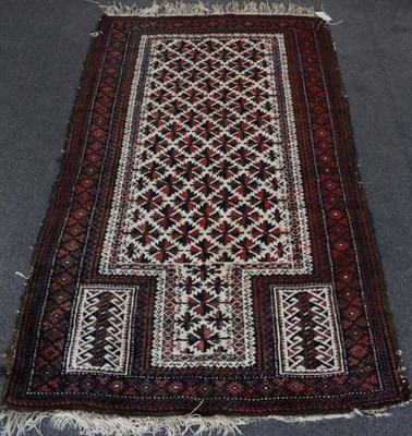 Lot 1354 - Balouch Prayer Rug West Afghanistan, circa 1920 The pale corn field of stylised flower heads...