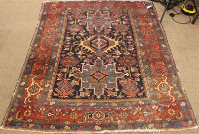 Lot 1355 - Heriz Rug Iranian Azerbaijan, circa 1900 The indigo field with three medallions enclosed by...