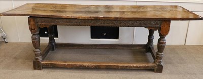 Lot 1377 - A 17th Century Joined Oak Refectory Dining Table, the plank top with cleated ends, raised on turned