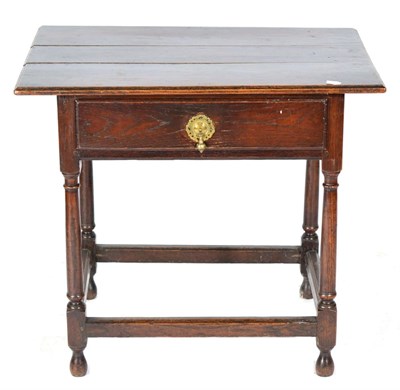 Lot 1378 - An 18th Century Joined Oak Table, the boarded top above a long frieze drawer, raised on turned...