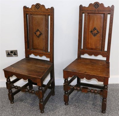 Lot 1381 - A Pair of Early 18th Century Joined Oak, Ebonised and Parquetry Decorated Hall Chairs, with...