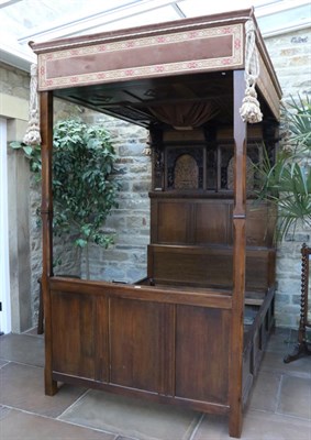 Lot 1383 - An Impressive Joined Oak Canopy Bedstead, the panelled headboard surmounted by a geometric...