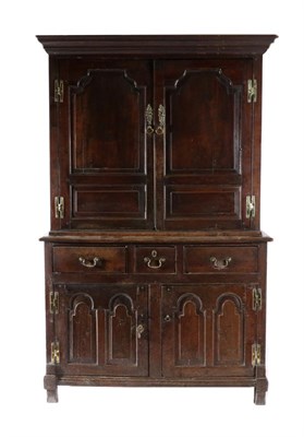 Lot 1385 - An 18th Century Joined Oak Kitchen Press Cupboard, the upper section with a bold cornice above...