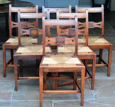 Lot 1390 - A Set of Six Oak Country and Rush-Seated Dining Chairs, 2nd quarter 19th century, with curved...