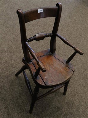 Lot 1399 - A Child's Beech and Elm Windsor Commode Armchair, late 19th century, with spindle arm supports...