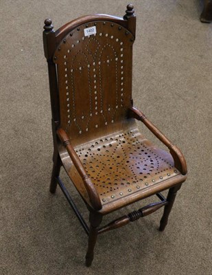 Lot 1402 - A Child's Stained Beech Armchair, circa 1900, with a brass studded pierced solid seat and...