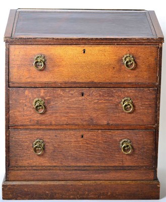 Lot 1408 - An Early 19th Century Oak Clerk's Desk, with leather writing slope above three deep drawers, raised