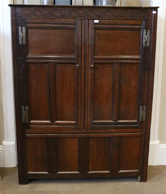 Lot 1416 - An 18th Century Joined Oak Livery Cupboard, with carved frieze above fielded cupboard doors...