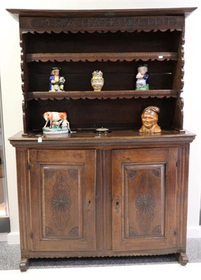 Lot 1419 - A 19th Century Continental Oak Dresser, with bold canopy above a carved frieze with initials...