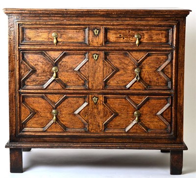 Lot 1420 - A 17th Century Oak Geometric Moulded Three Drawer Straight Front Chest of Drawers, raised on...