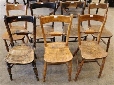 Lot 1424 - A Matched Set of Seven 19th Century Elm Provincial Dining Chairs, with curved top rails above...