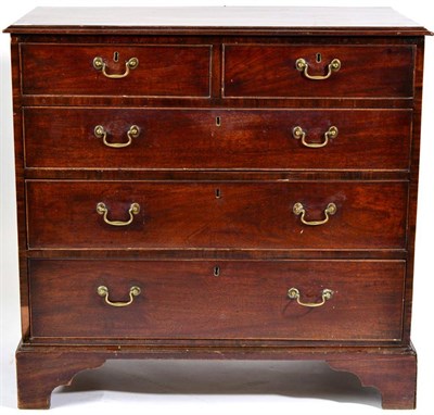 Lot 1449 - A George III Mahogany Straight Front Chest of Drawers, early 19th century, with moulded top...