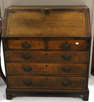 Lot 1467 - A George III Mahogany and Crossbanded Bureau, late 18th century, the fall enclosing a fitted...