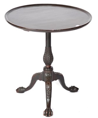 Lot 1474 - A Mahogany Fliptop Tripod Table, the associated moulded top raised on a carved baluster support...