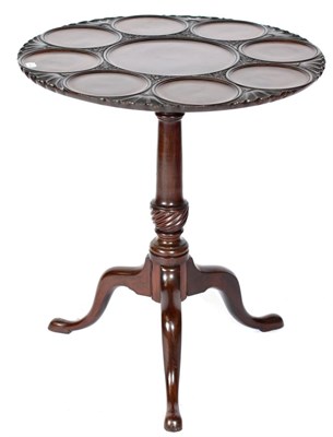 Lot 1475 - A Carved Mahogany Fliptop Tripod Table, the circular top made up of a central panel surrounded...