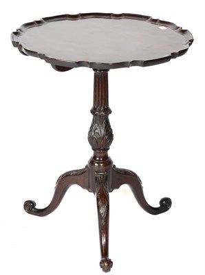 Lot 1477 - A George III Mahogany Fliptop Tripod Table with associated moulded pie crust top above a fluted and